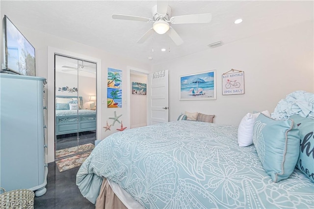 carpeted bedroom with ceiling fan and a closet