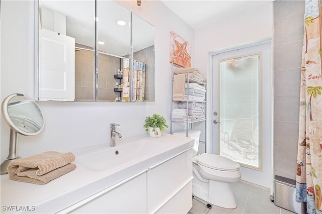 bathroom featuring tile patterned floors, vanity, toilet, and a shower with shower curtain