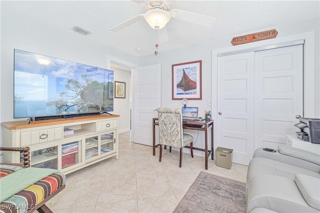 home office featuring ceiling fan and light tile patterned floors