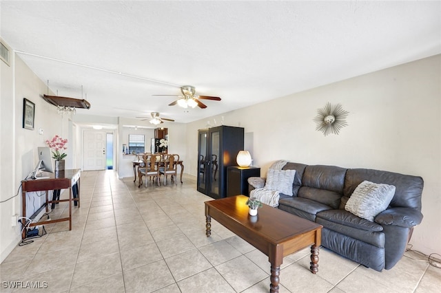 tiled living room with ceiling fan