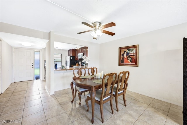 dining area featuring ceiling fan and light tile patterned floors