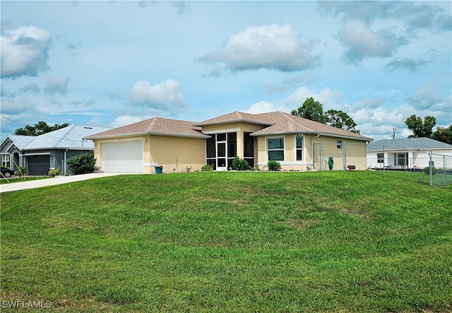 view of front of home with a front yard and a garage