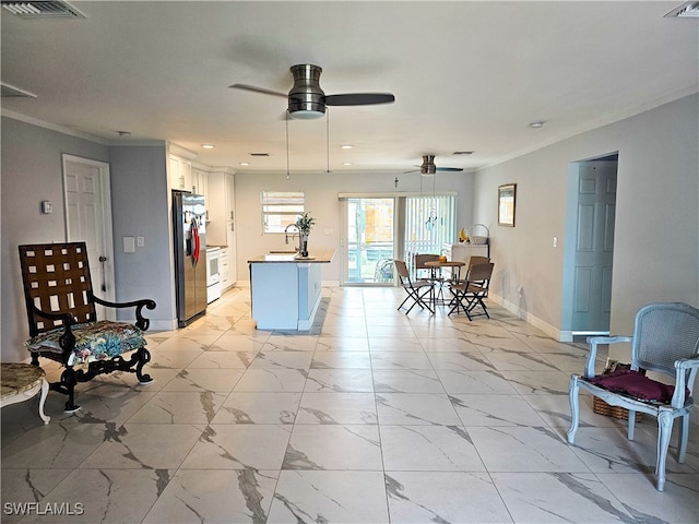 living room with ceiling fan, crown molding, and sink