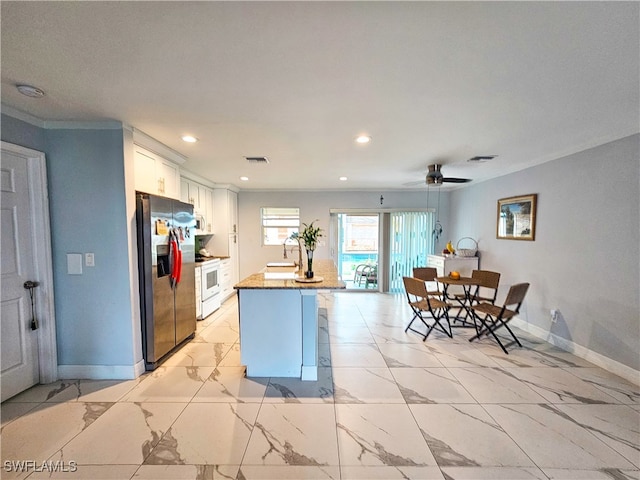 kitchen with a kitchen island with sink, stainless steel fridge with ice dispenser, white cabinets, ceiling fan, and white range with electric cooktop