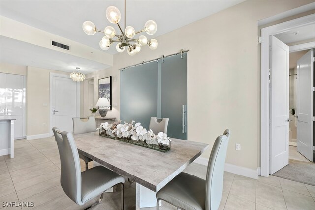 dining area with a barn door, light tile patterned floors, and an inviting chandelier