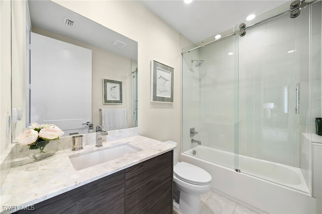 full bathroom featuring tile patterned flooring, vanity, bath / shower combo with glass door, and toilet