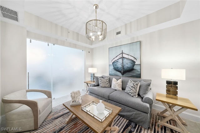 tiled living room featuring a chandelier