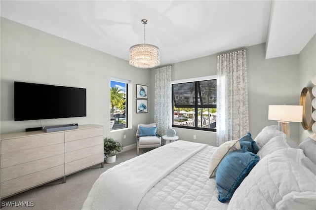 carpeted bedroom with a chandelier