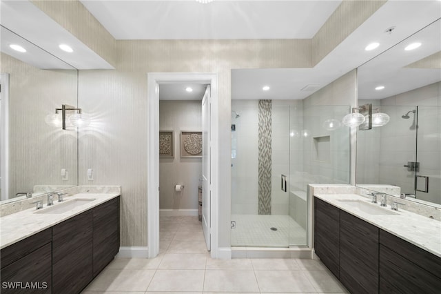 bathroom with tile patterned flooring, vanity, and walk in shower