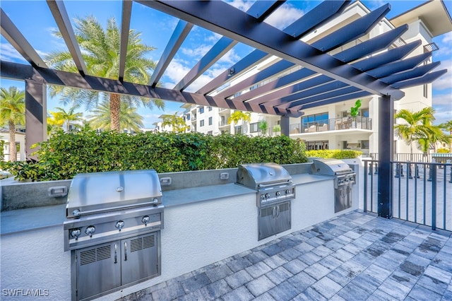 view of patio / terrace featuring a pergola, a grill, and an outdoor kitchen