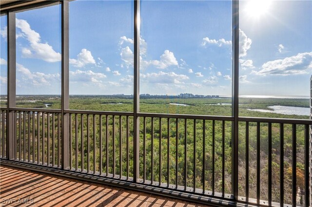 unfurnished sunroom featuring a water view