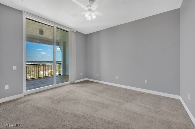 unfurnished room with light colored carpet and ceiling fan