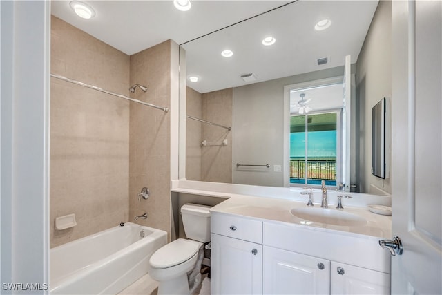 full bathroom featuring toilet, vanity, and tiled shower / bath