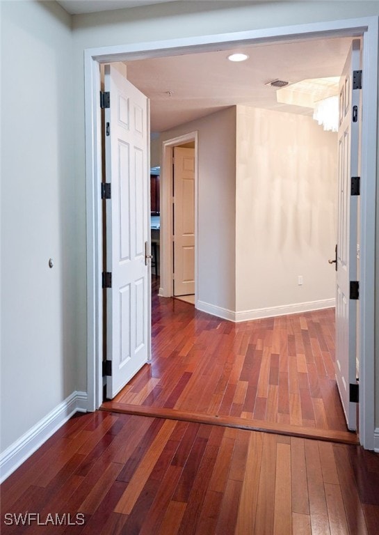 corridor with wood-type flooring