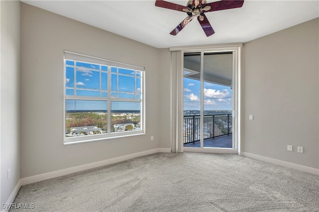 empty room featuring carpet flooring, plenty of natural light, and ceiling fan