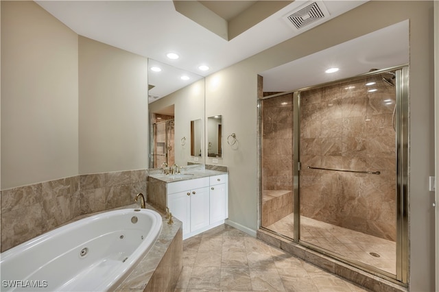 bathroom with vanity and separate shower and tub