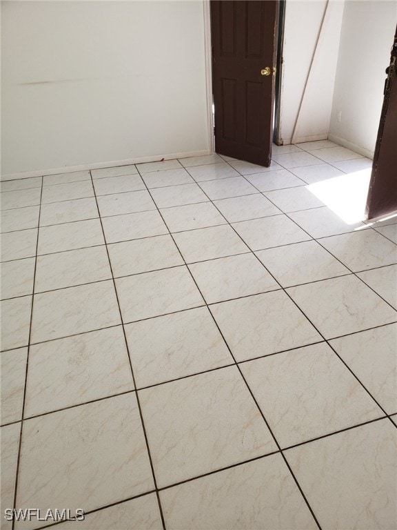 spare room featuring light tile patterned floors