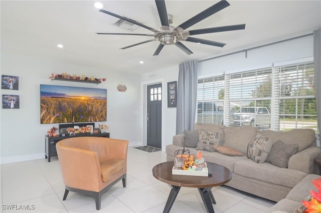 living room with ceiling fan and light tile patterned floors