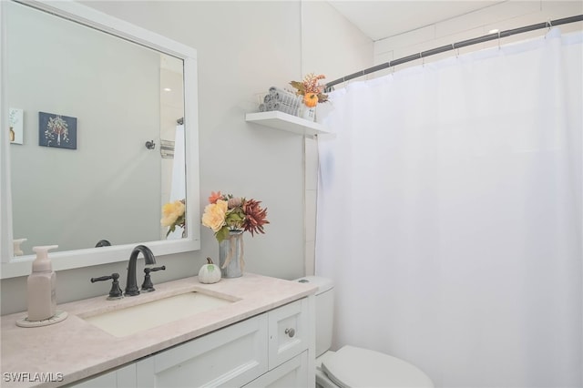 bathroom featuring vanity, toilet, and curtained shower