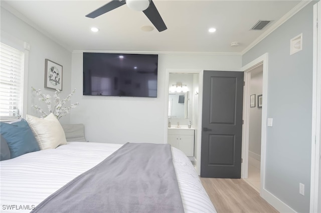 bedroom with ornamental molding, ensuite bathroom, light hardwood / wood-style floors, and ceiling fan