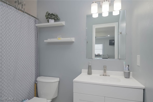 bathroom featuring vanity and toilet