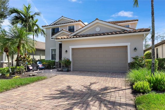 mediterranean / spanish-style house with a garage