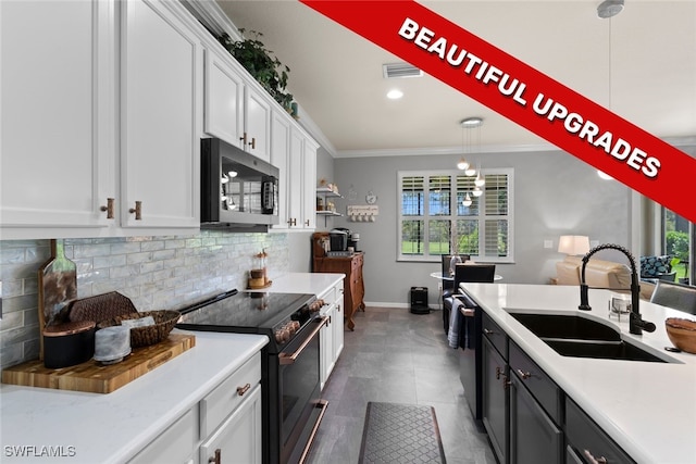 kitchen with sink, white cabinetry, ornamental molding, pendant lighting, and stainless steel appliances