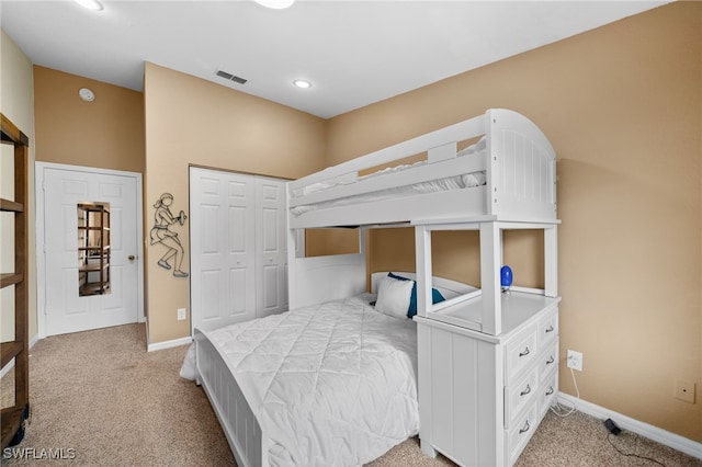 bedroom with light colored carpet and a closet