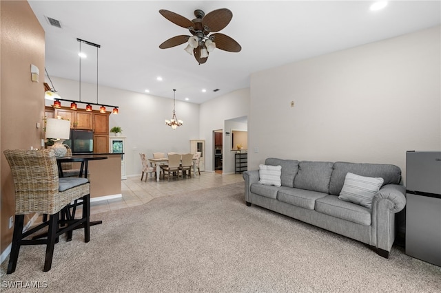 living room featuring ceiling fan with notable chandelier