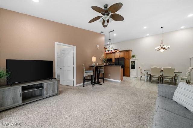 living room featuring ceiling fan with notable chandelier