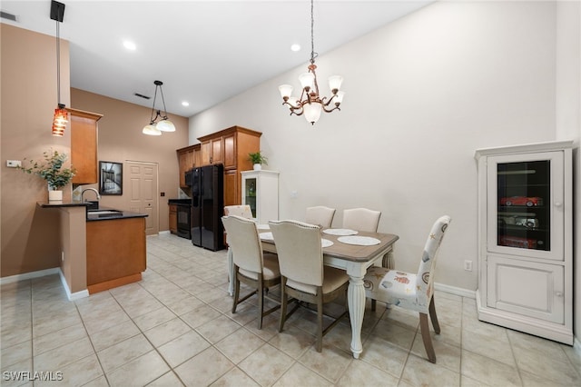 dining area featuring light tile patterned flooring, sink, and an inviting chandelier