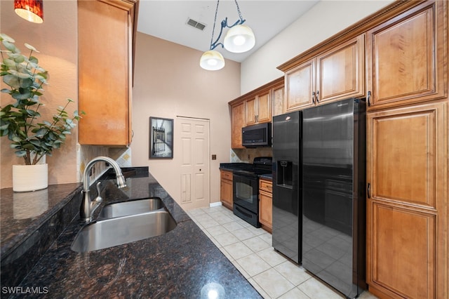 27083 Matheson Ave Unit 202, Bonita Springs, FL 34135 - kitchen featuring black appliances, a sink, light tile patterned flooring, brown cabinetry, and pendant lighting