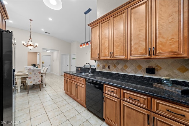 kitchen featuring decorative light fixtures, sink, black dishwasher, stainless steel fridge, and a chandelier