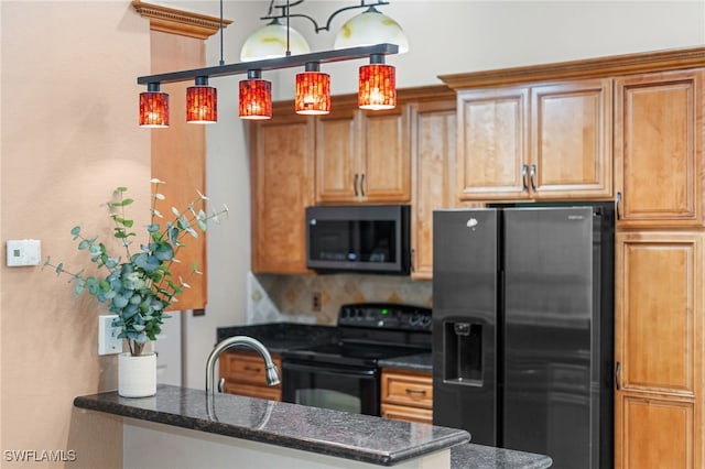 kitchen with kitchen peninsula, hanging light fixtures, dark stone counters, black appliances, and sink