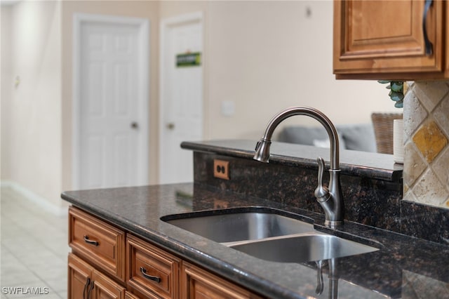 27083 Matheson Ave Unit 202, Bonita Springs, FL 34135 - kitchen with a sink, brown cabinets, and dark stone counters