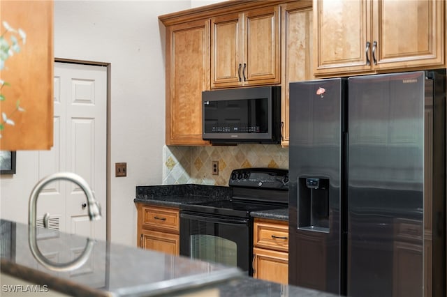 kitchen featuring stainless steel refrigerator with ice dispenser, black electric range, tasteful backsplash, and dark stone counters