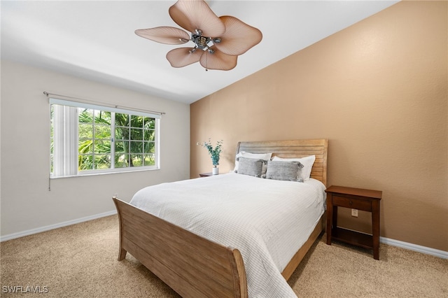 bedroom with ceiling fan, light carpet, and lofted ceiling