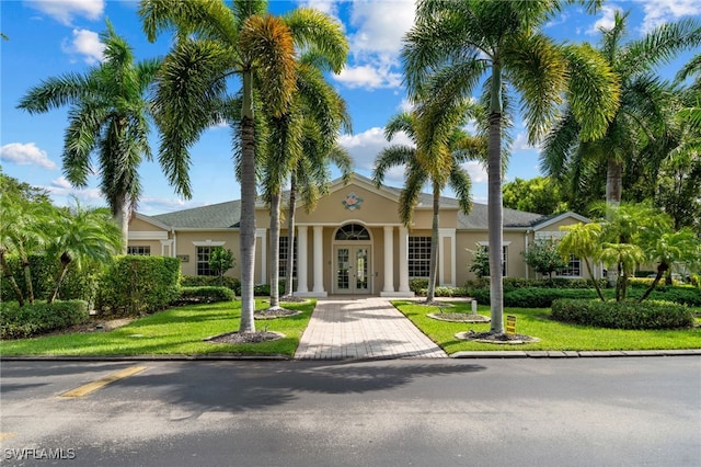 view of front of property featuring a front lawn and french doors