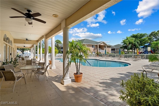 view of swimming pool with ceiling fan and a patio area