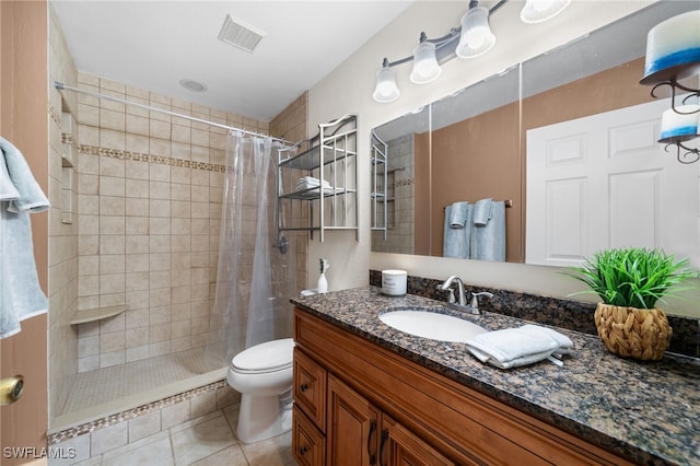 bathroom with toilet, a shower with shower curtain, tile patterned flooring, and vanity