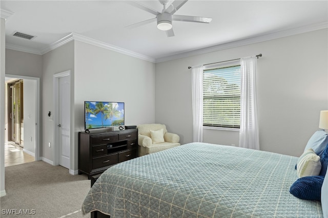 carpeted bedroom featuring ceiling fan and ornamental molding