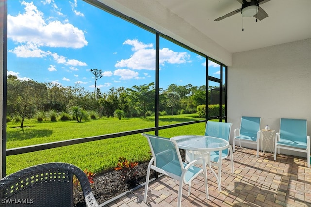 sunroom / solarium featuring ceiling fan