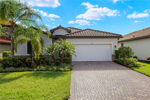 mediterranean / spanish-style house with a front yard and a garage