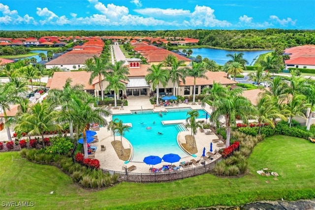 view of pool with a patio area and a water view