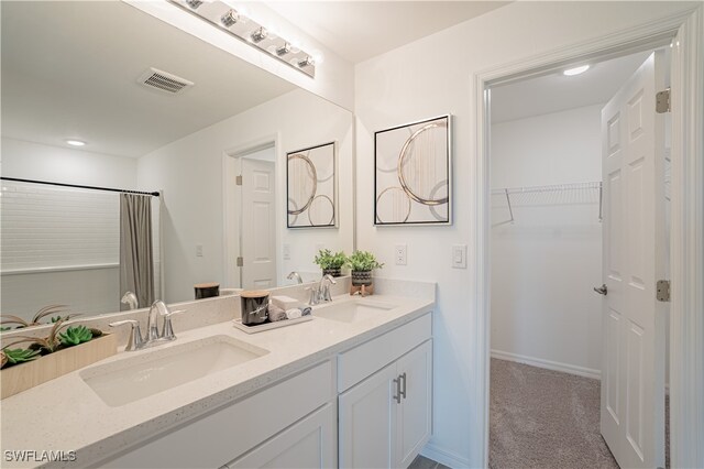 bathroom with curtained shower and vanity