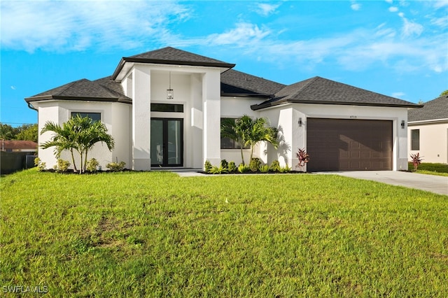 prairie-style house with cooling unit, a front lawn, and a garage