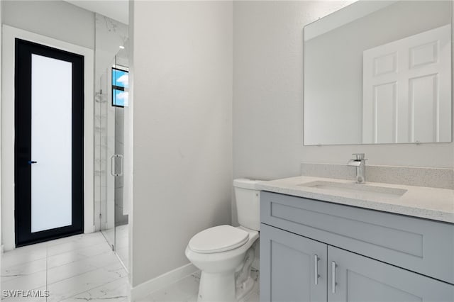 full bath with vanity, marble finish floor, toilet, baseboards, and a marble finish shower