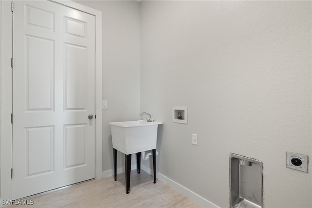 washroom with laundry area, baseboards, light wood-type flooring, washer hookup, and hookup for an electric dryer