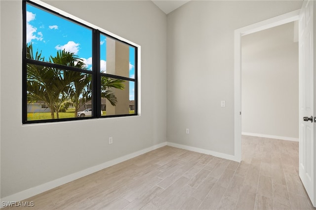 spare room with light hardwood / wood-style floors and a healthy amount of sunlight