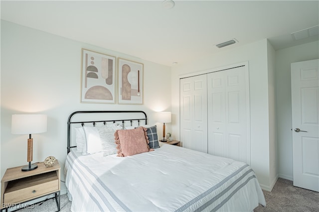 bedroom featuring a closet and light colored carpet